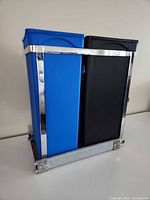 front view of frame with blue and black bins inserted