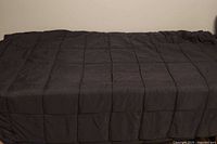 full view of grey weighted blanket laid out