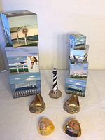 Full view of all items including the nesting boxes, lighthouse figurine, metal sailboat bookends, and sailor heads