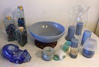 Image showing the complete lot with glass canisters, ceramic cat, high heel shoe, and blue candles arranged on a table.