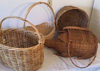 Overview of four wicker baskets showing the pig-shaped basket alongside three oval and round baskets.