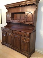 Large wooden hutch front view showing drawers, cabinets, and shelves in walnut finish