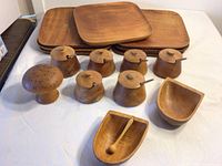 Full set showing 7 square wooden plates, 6 lidded pots with spoons, mushroom-shaped item with holes, and 2 bowls.