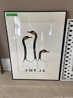 Front view of black-framed Benjamin Chee Chee print depicting three stylized waterfowl