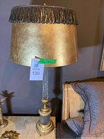 Full view of one lamp showing shade, column and base