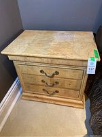 Front corner view showing burl veneer top and side profile of nightstand