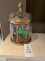 Front view of jar showing bubble glass panels and brass frame