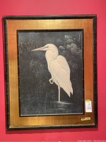 Full view of framed Great White Heron artwork against red wall