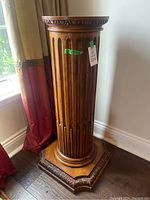 Full view of wooden pedestal stand showing overall design and finish