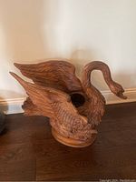Full view of carved wooden swan planter showing overall form and hollow center