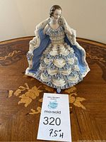 Front view showing full figurine with lot card indicating size