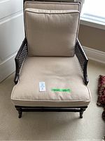 Full front view of occasional chair showing frame and cushions