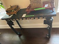 Full view of rectangular tabletop, fluted apron and two elephant trunk legs