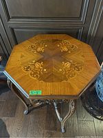 Full top-down view of octagonal tabletop showing floral inlay pattern.