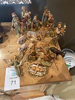 Full view of all 15 resin nativity set pieces displaying characters and animals arranged on table.