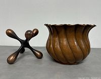 Planter and jacks sculpture side by side showing size, color and texture.