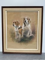 Full view of framed painting showing the two dogs sitting side by side in a muted tone background, framed in wood with cream mat.