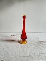 Full frontal view of the vintage amberina vase showing the color gradient from amber yellow base to red neck and hobnail texture on lower midsection.