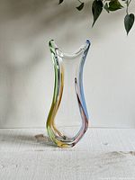 Full view of the 16 inch Czech Rhapsody vase showing its curved, multicolor edges with green, yellow, blue, and purple hues.