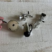 Photo of all four vintage kitchen magnets laid out on beige surface.