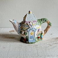 Front side showing main door, bunny figure, mushrooms, and garden paint details.