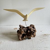 Full view of wood burl driftwood base with cream-colored seagull bird suspended on wire