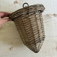 Side view showing textured natural brown wicker weave and shape of planter