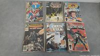 Six comics displayed in plastic sleeves: US1 #1, Beauty and the Beast, Buckaroo Banzai, Starriors, Crash Ryan, Secret Wars