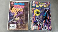 Photo showing Batman vs Predator #2 and a Batman Detective Comics issue