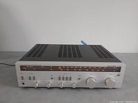 Front view showing illuminated AM/FM dial, control knobs and model marking