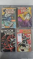 Four different Moon Knight comic books laid out, showing cover art for various issues.
