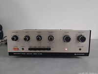 Front view of vintage Kenwood KA-4002 amplifier showing controls and power indicator light on.