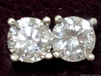 Closeup of diamond studs showing round brilliant diamonds and four-prong settings