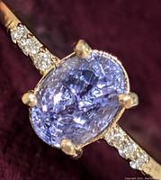 Front view of ring showing oval tanzanite and diamond accents