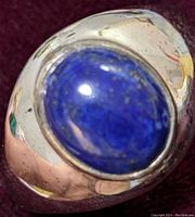 Close-up photo of ring's lapis lazuli cabochon set in rounded sterling silver band.