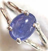 Close-up front view of the sterling silver ring with oval tanzanite stone showing prong setting and band details.