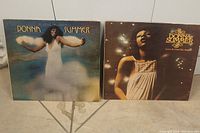 Front covers of two Donna Summer vinyl albums including 'A Love Trilogy' and 'Love to Love You Baby'.