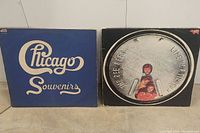 Side by side vinyl album covers: Chicago Souvenirs and The Bee Gees Life in a Tin showing front artwork and condition.