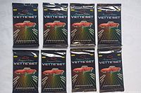 Eight sealed packs of 1985 Inaugural Edition Vette'Set Corvette collector cards laid out flat showing the front of each pack.
