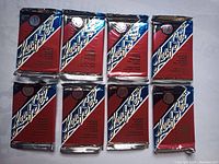 Eight sealed Leaf Set MLB baseball card packs arranged in two rows of four, featuring red, white, and blue diagonal design and foil edges.