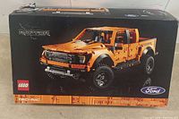 Front of LEGO Technic Ford F-150 Raptor box with image of the completed orange truck and branding.