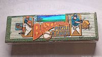Front view of sealed 1990 Donruss Baseball Puzzle & Cards box with illustrations and certification seal.