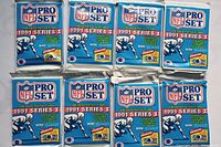 Eight sealed packs of 1991 NFL Pro Set Series 1 football cards arranged in two rows of four.