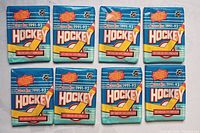 Eight sealed 1991-92 O-Pee-Chee NHL hockey card packs displayed in two rows of four, showing original blue packaging with hockey-themed graphics and text.