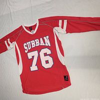 Red hockey-style jersey with SUBBAN and number 76 on front, laid flat to show full front design and sleeve details.