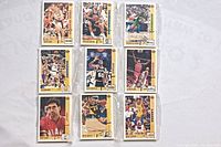 Nine vintage NBA basketball cards displayed in three rows of three, showing a variety of players and teams in action and posed shots.