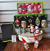 Wide photo showing all items on a wooden bamboo surface and a white tiered stand, with mats and the pouch in background