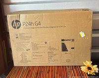 The original box for the HP P24h G4 monitor showing the front with brand name, model, screen size 23.8" diagonal and regulatory details in multiple languages.