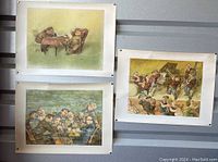 Three framed vintage poster prints hanging on wall depicting chess players, a jazz band, and a group socializing