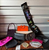 Lot of vintage wristlets, coin purses and banner arranged on wooden surface with silver background.